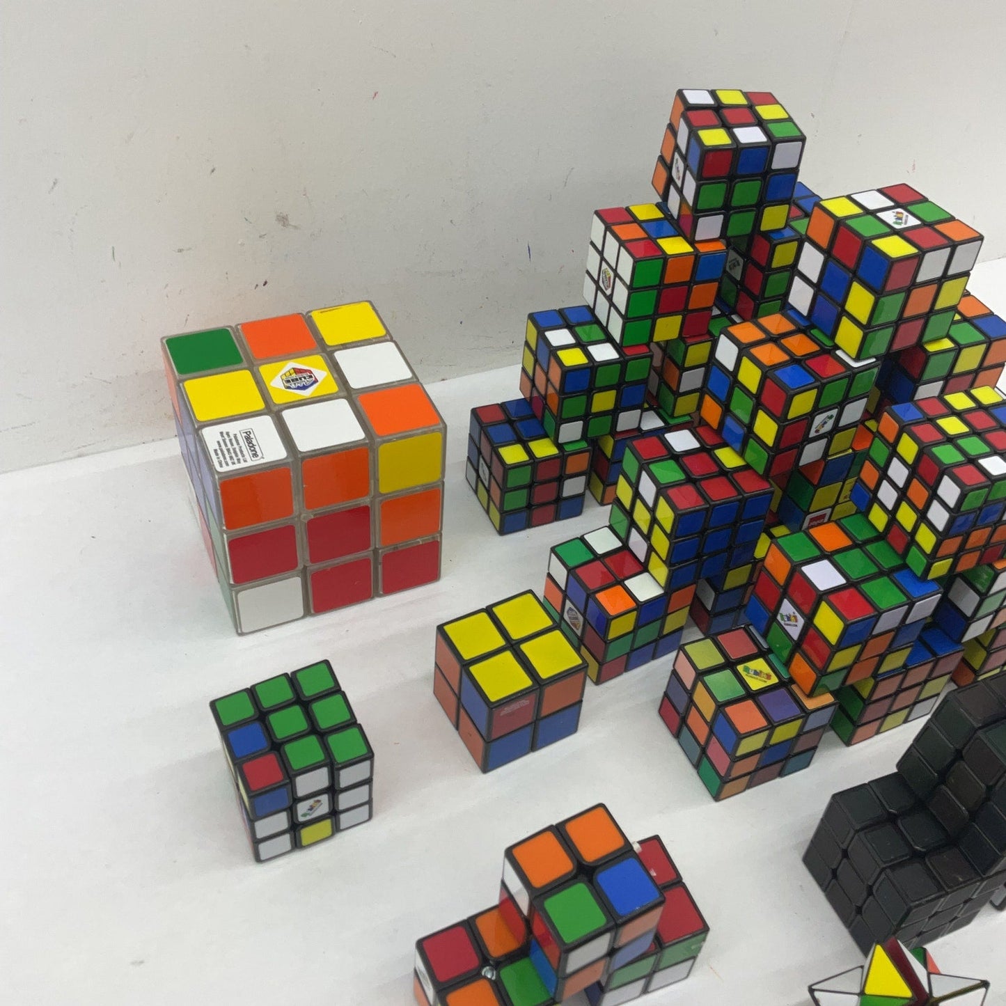 Preowned Mixed LOT 10 lbs Rubik's Cube & Other Brain Teaser Puzzle Square Toys - Warehouse Toys