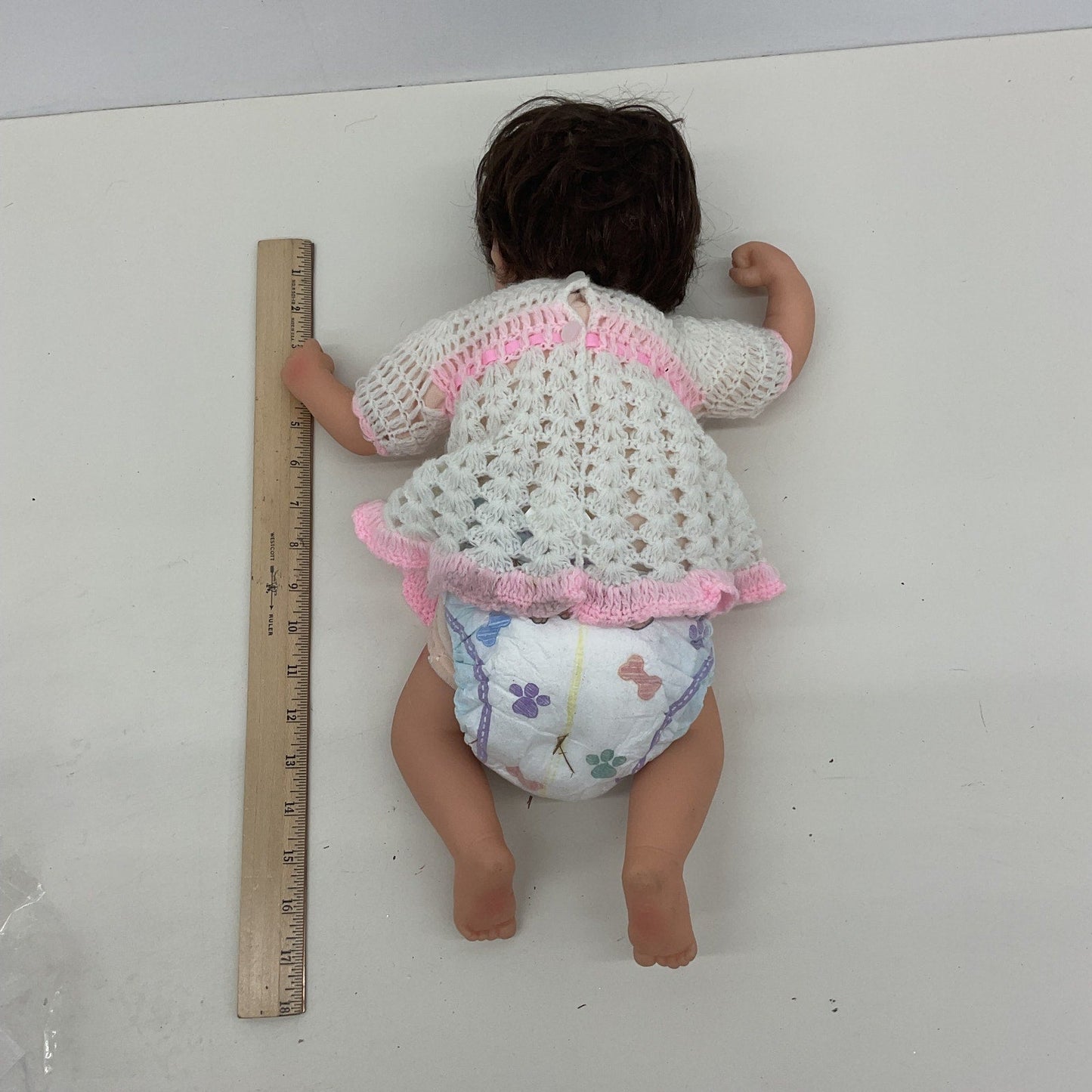 Unbranded Numbered Realistic Brunette Baby Doll in White Dress - Warehouse Toys